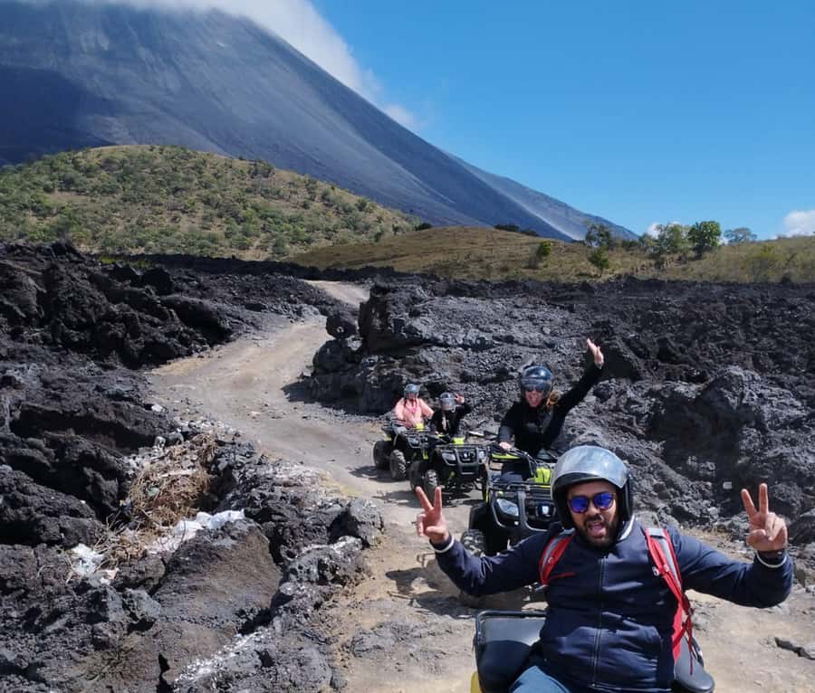 Antigua: Pacaya Volcano ATV Tour - Riding near Pacaya: lava, volcanic sand, and village-area scenes