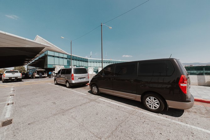 Private Transportation Service Within Guatemala City on a Minibus with A/C - La Aurora pickup at the Pink Gate Exit, with a name sign